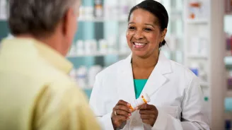 Pharmacist Smiling at Customer
