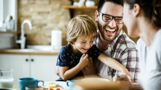 Family in Kitchen Laughing