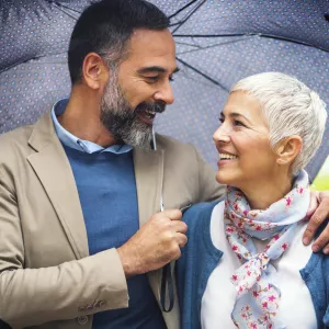 Woman and Man Walking Outdoors in Rain