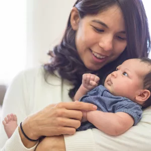 Mother cradling baby