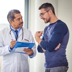 Adult White Man Discusses His Condition With A Doctor