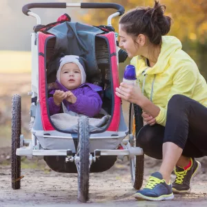 Mom Walking in Park With Baby in Stroller