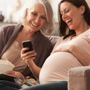 Pregnant Woman With Mom Looking at Phone