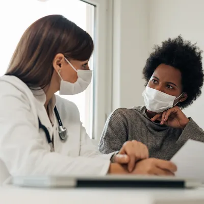 Doctor Speaking With Patients About Treatment with Masks 