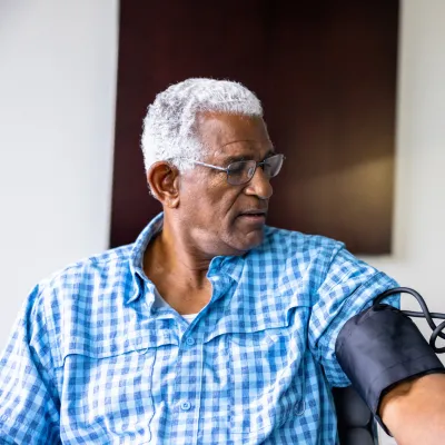 A Patient Has His Blood Pressure Taken By a Nurse in a Practice.