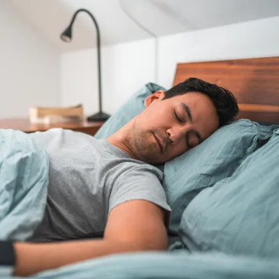 A Man Sleeps in His Bed at Home