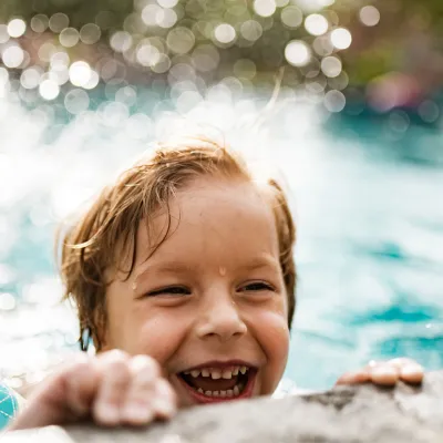 Boy swimming in pool.