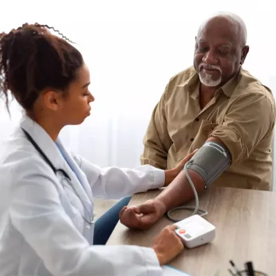 A Physician Checks Her Patient's Blood Pressure