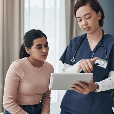 A Doctor Goes Over a Chart with her Patient.