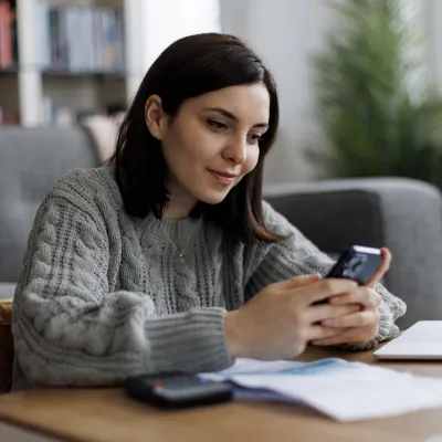 A young woman looking at her phone.