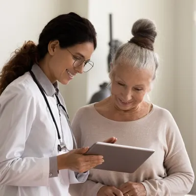 Physician Showing Hispanic Woman Her Test Results