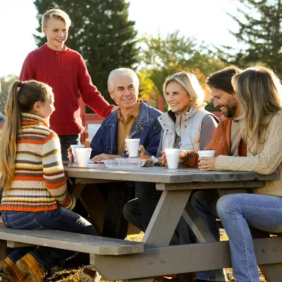 Family sitting outside at a picnic table