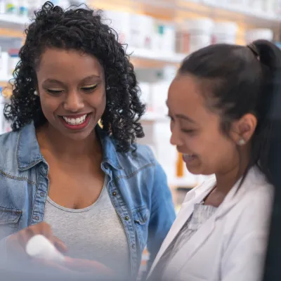 Pharmacist Helping Woman Find Medication.