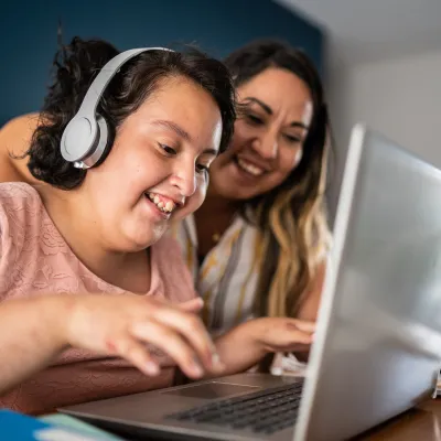 Autistic Child With Headphones on Using Computer