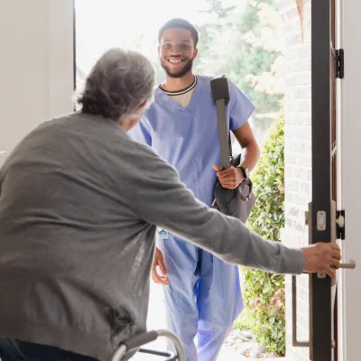 Nurse visiting patient at home.