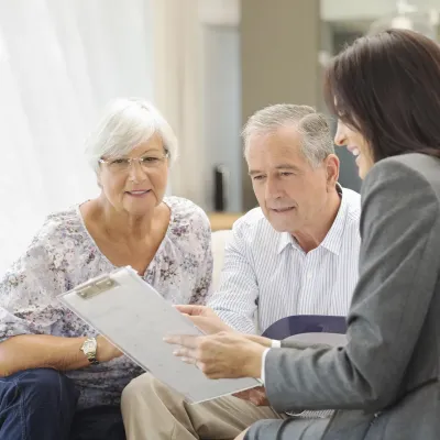 Senior couple talking to financial advisor.