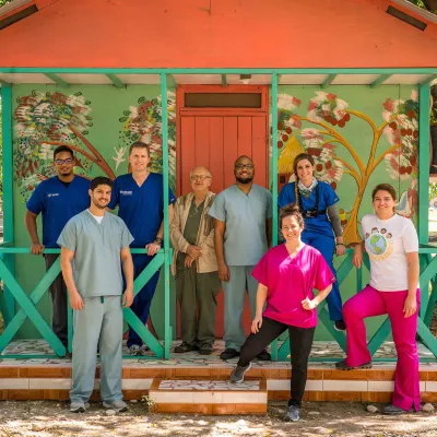 physicians in front of a decorative house