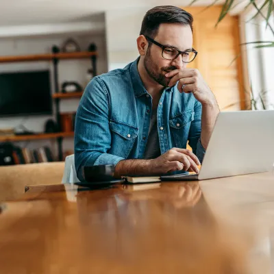 A man doing research on a laptop.