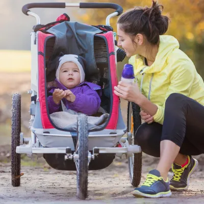 Mom Walking in Park With Baby in Stroller