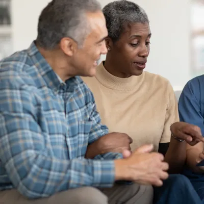An older couple reviews their test results with their doctor.