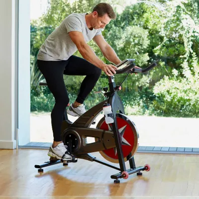 A man riding an exercise bike at home.