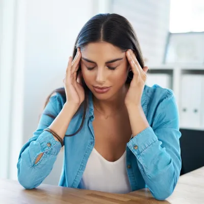 A woman applying a physical technique on her temples