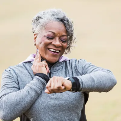 Female runner checking her wearable device