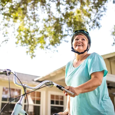 Woman with bike with helmet on