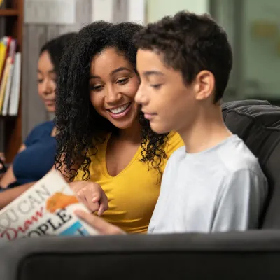 Son Showing Mom Page in Book