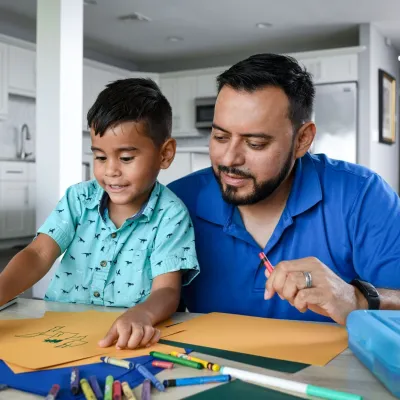 Man with his son coloring