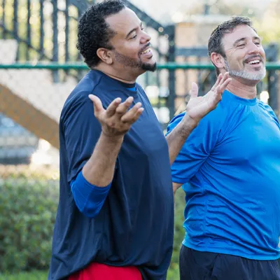 Group of men staying healthy playing basketball
