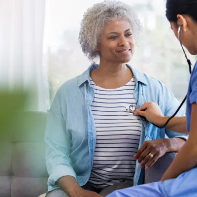 Female Doctor Listening to Woman's Heart