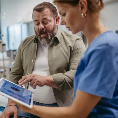 A male patient talks with a female doctor about his test results.