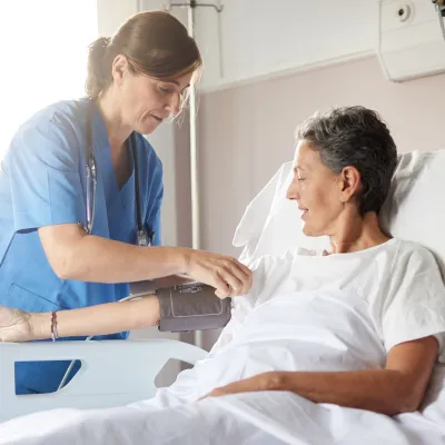 Nurse and patient in hospital room.