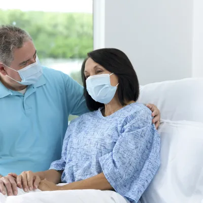 Patient with Family visitor in hospital bed