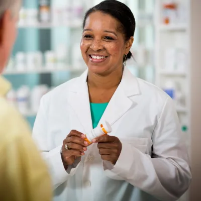 Pharmacist Smiling at Customer