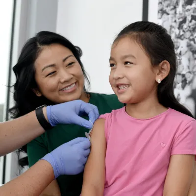A Nurse Puts a Band Aid on a Child Patient after an Injection