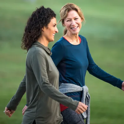 Two Women Walking and Smiling