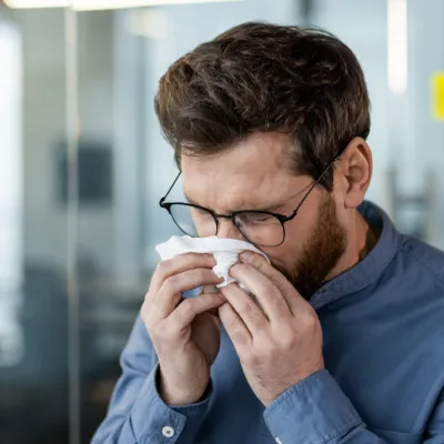 A man blowing his nose.