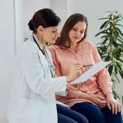 A woman and her healthcare provider looking at a document together.