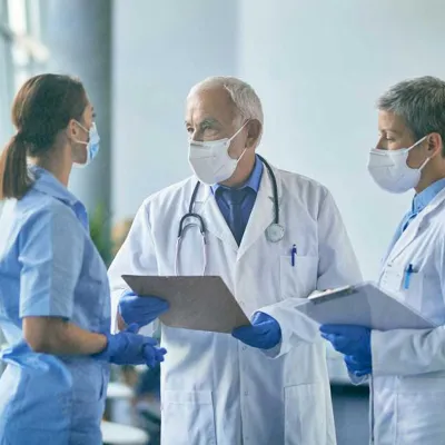 Doctor talking to nurses about patient