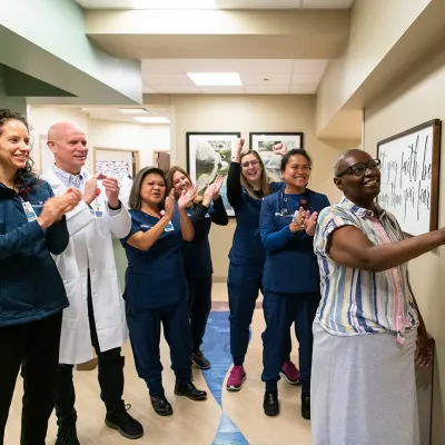 Women Ringing Radiation Oncology Bell