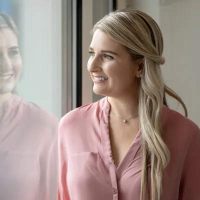 Female patient in office looking out through window.