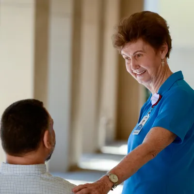 Volunteer Helping Patient
