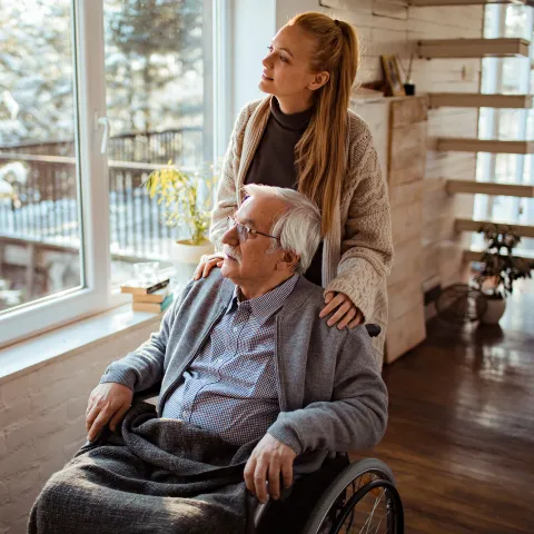 Caregiver Looks Out the Window with a Senior Patient