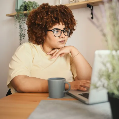 Woman on Laptop Checking Bills
