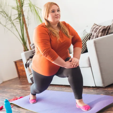A Woman Stretches During Yoga in Her Home