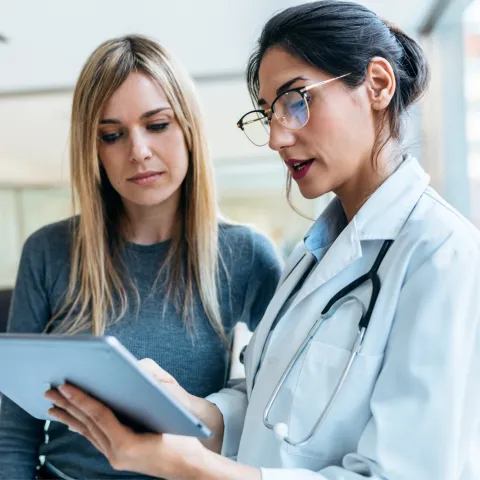Female Patient Looking at Tablet With Female Doctor