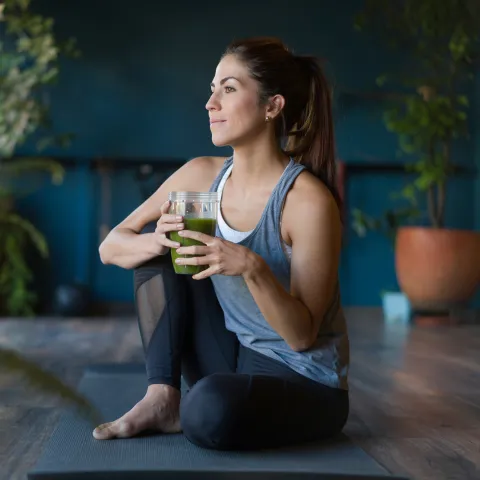 A woman stretching at home.