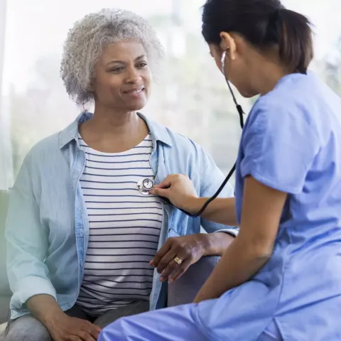 Physician Checking Patient's Heart